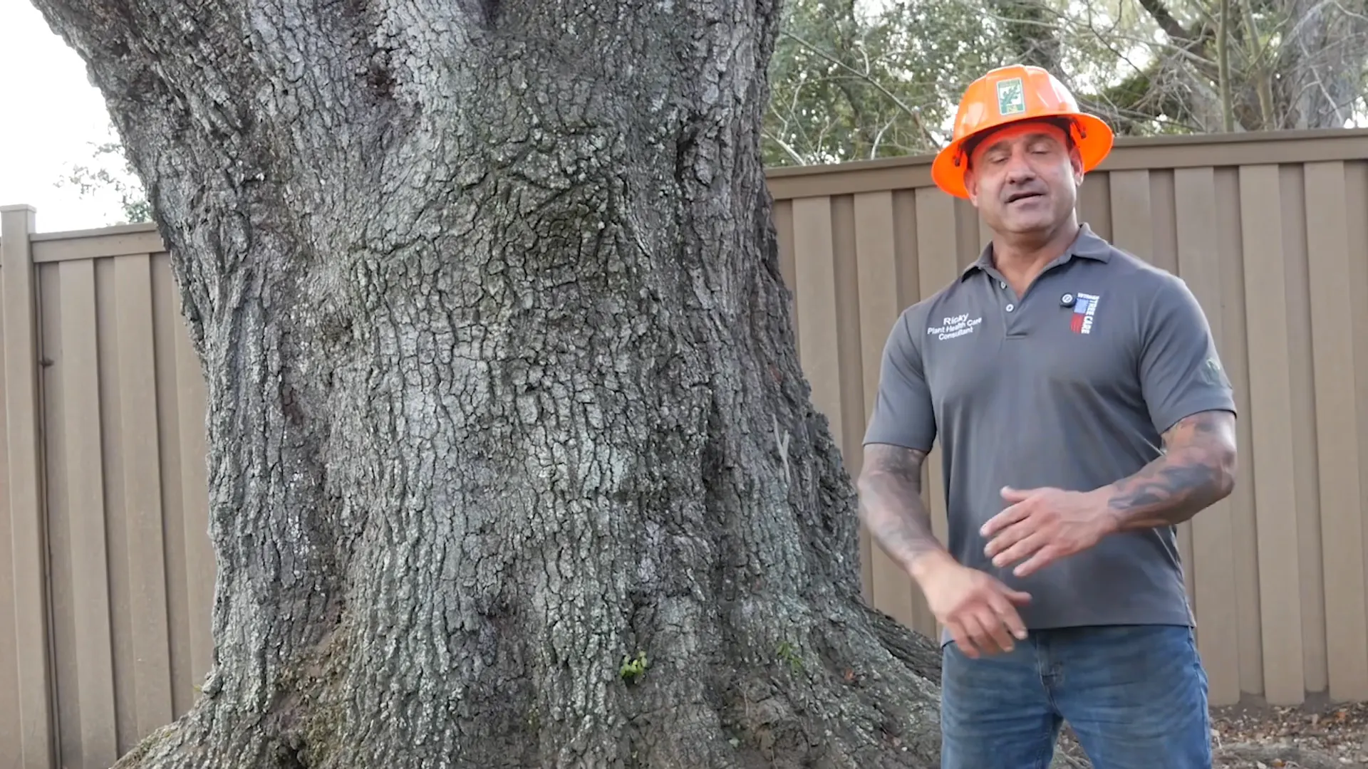 Ricky Folse beside a massive live oak